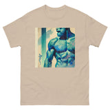 Gay muscular man with. beard rippling bulging muscles. T-shirt in a watercolor design great for dates the gym club wear going out. Super sexy fit. Sand color tshirt with blue graphic. Front
