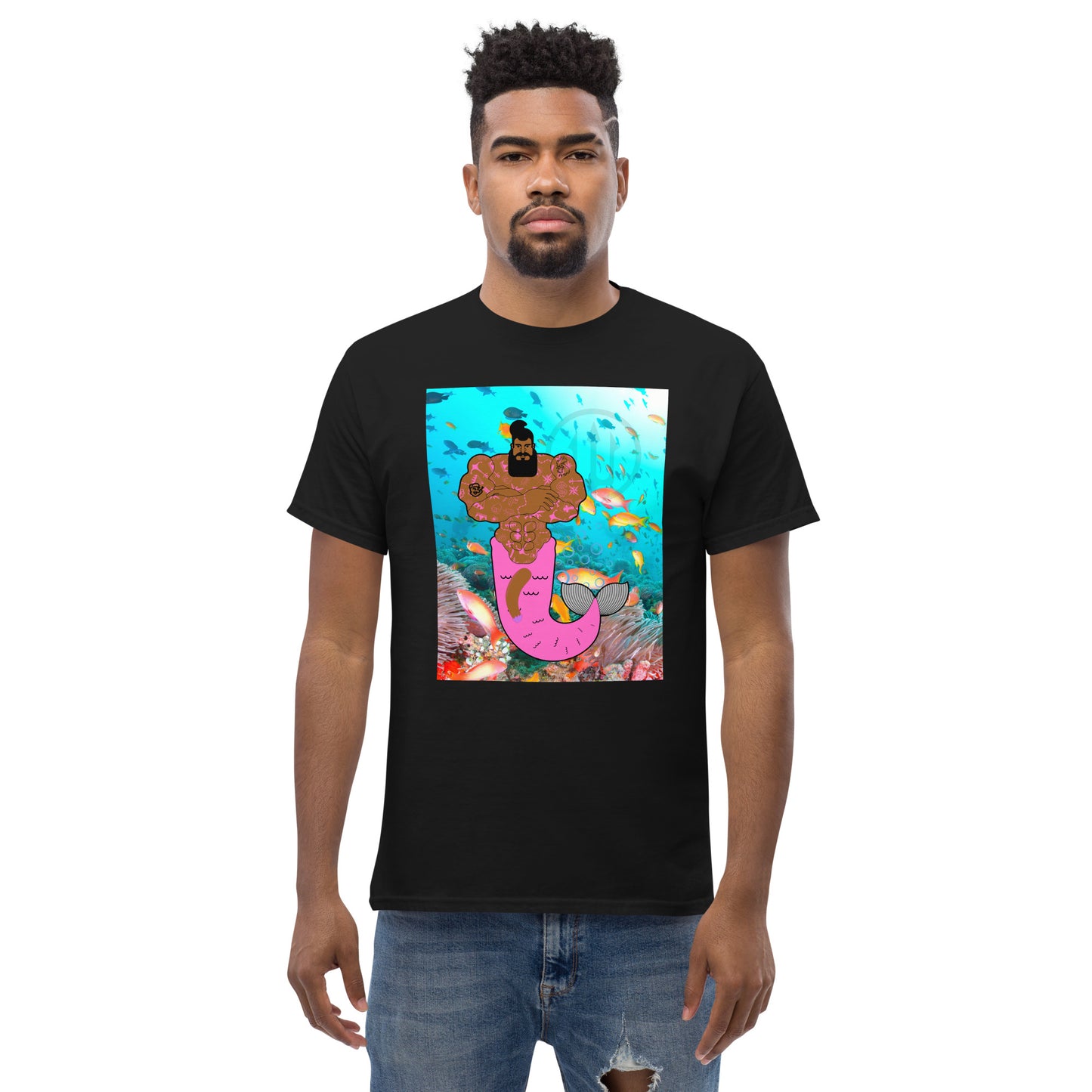 Black t-shirt with a vibrant graphic of a muscular merman covered in tattoos, swimming in a deep blue ocean.