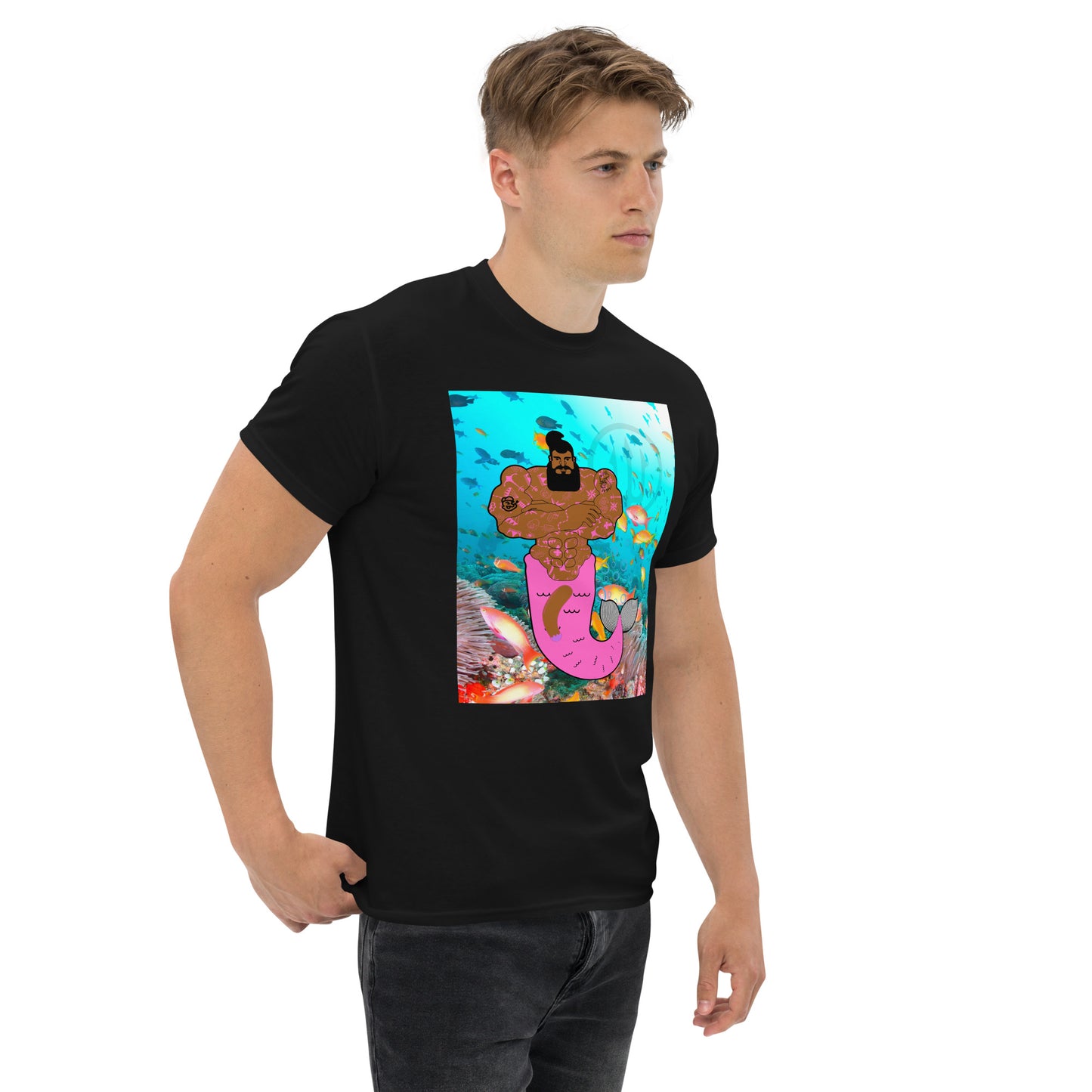 Black t-shirt with a vibrant graphic of a muscular merman covered in tattoos, swimming in a deep blue ocean.